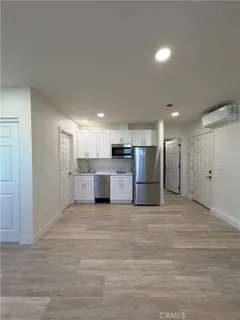 a kitchen with white cabinets and sink