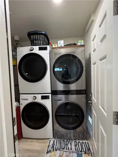 a kitchen with white cabinets and sink