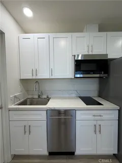 a kitchen with a sink and cabinets