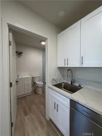 a bathroom with a toilet a sink and glass door