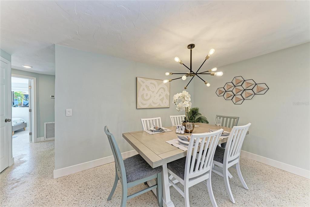 730 Fox Street Longboat Key, FL 34228 - Photo 14 of 40 a dining room with furniture and wooden floor