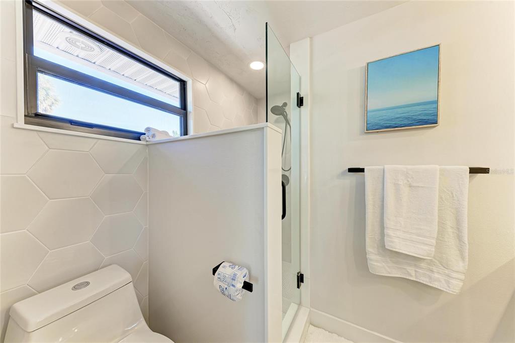 730 Fox Street Longboat Key, FL 34228 - Photo 23 of 40 a bathroom with a toilet and a shower