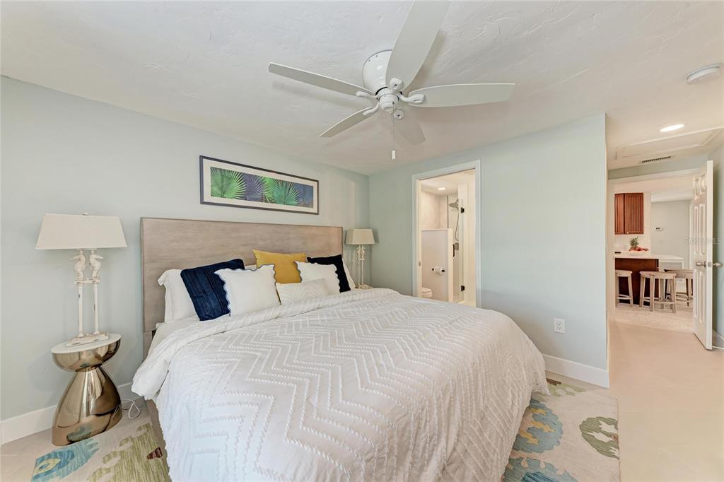 730 Fox Street Longboat Key, FL 34228 - Photo 25 of 40 a bedroom with a bed and a chandelier