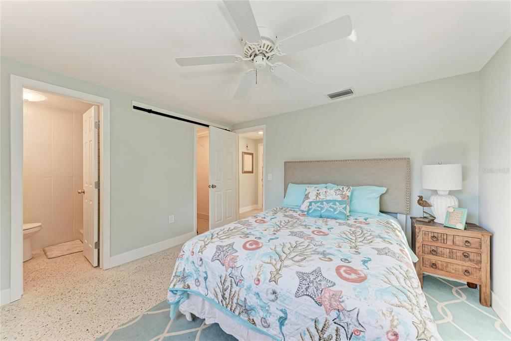 730 Fox Street Longboat Key, FL 34228 - Photo 27 of 40 a bedroom with a bed and a chandelier