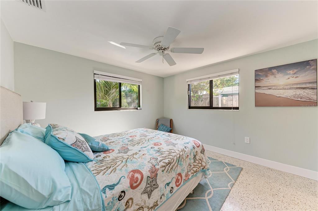 730 Fox Street Longboat Key, FL 34228 - Photo 28 of 40 a bedroom with a large bed and a chandelier