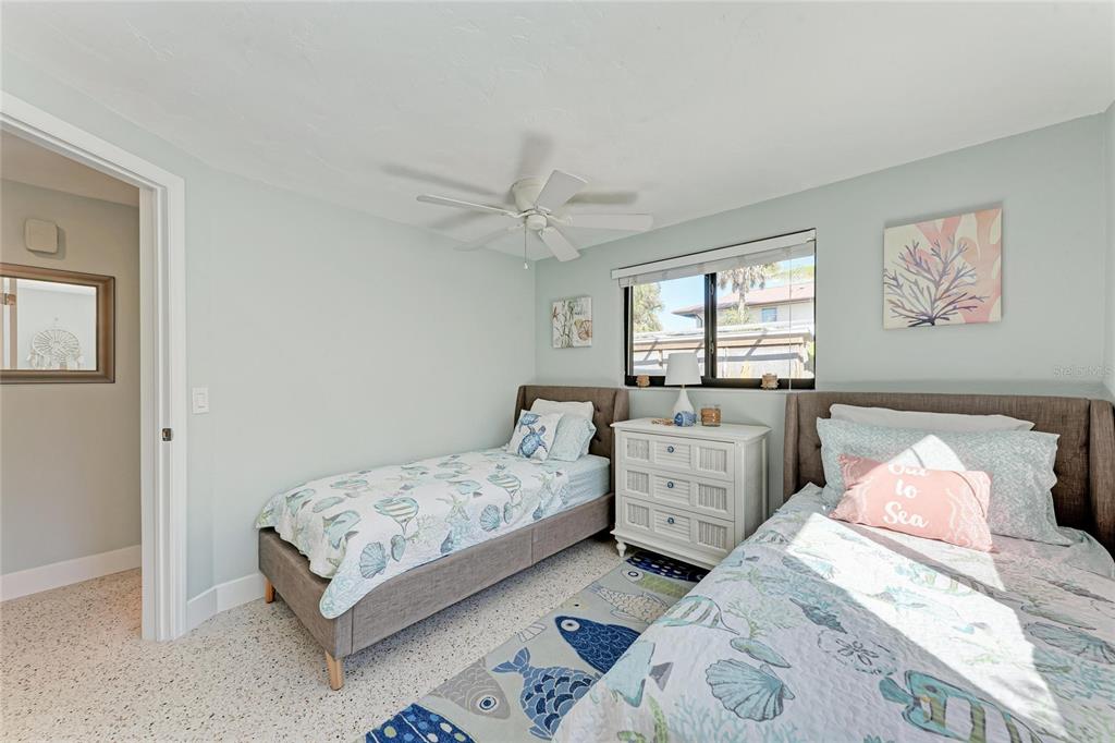 730 Fox Street Longboat Key, FL 34228 - Photo 31 of 40 a bedroom with a bed and a chandelier