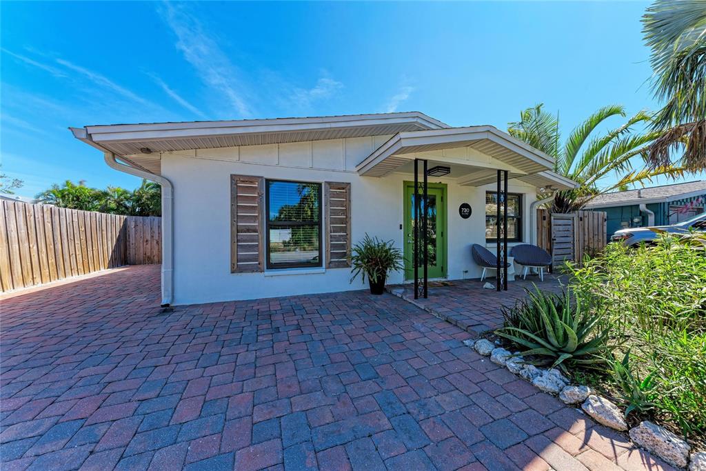 730 Fox Street Longboat Key, FL 34228 - Photo 4 of 40 a front view of a house with garden