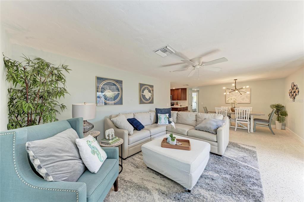 730 Fox Street Longboat Key, FL 34228 - Photo 9 of 40 a living room with furniture and a large window with garden view