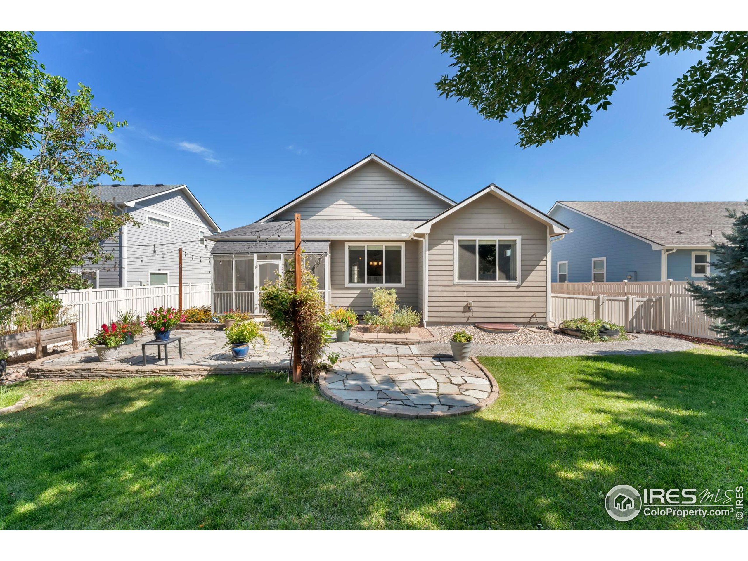 11449 Coal Ridge Street Firestone, CO 80504 - Photo 13 of 33 a front view of a house with a garden and patio