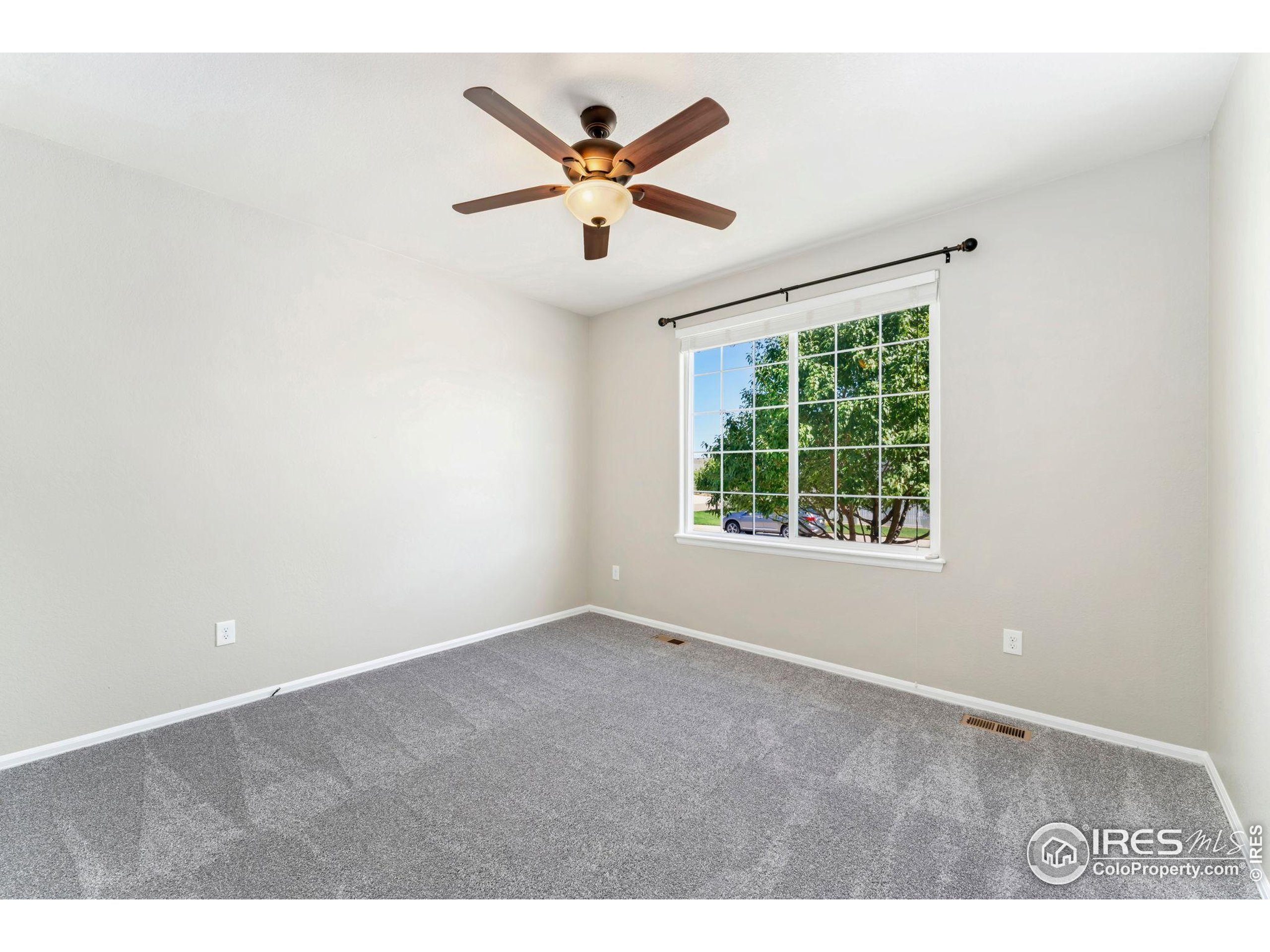 11449 Coal Ridge Street Firestone, CO 80504 - Photo 19 of 33 an empty room with ceiling fan and window
