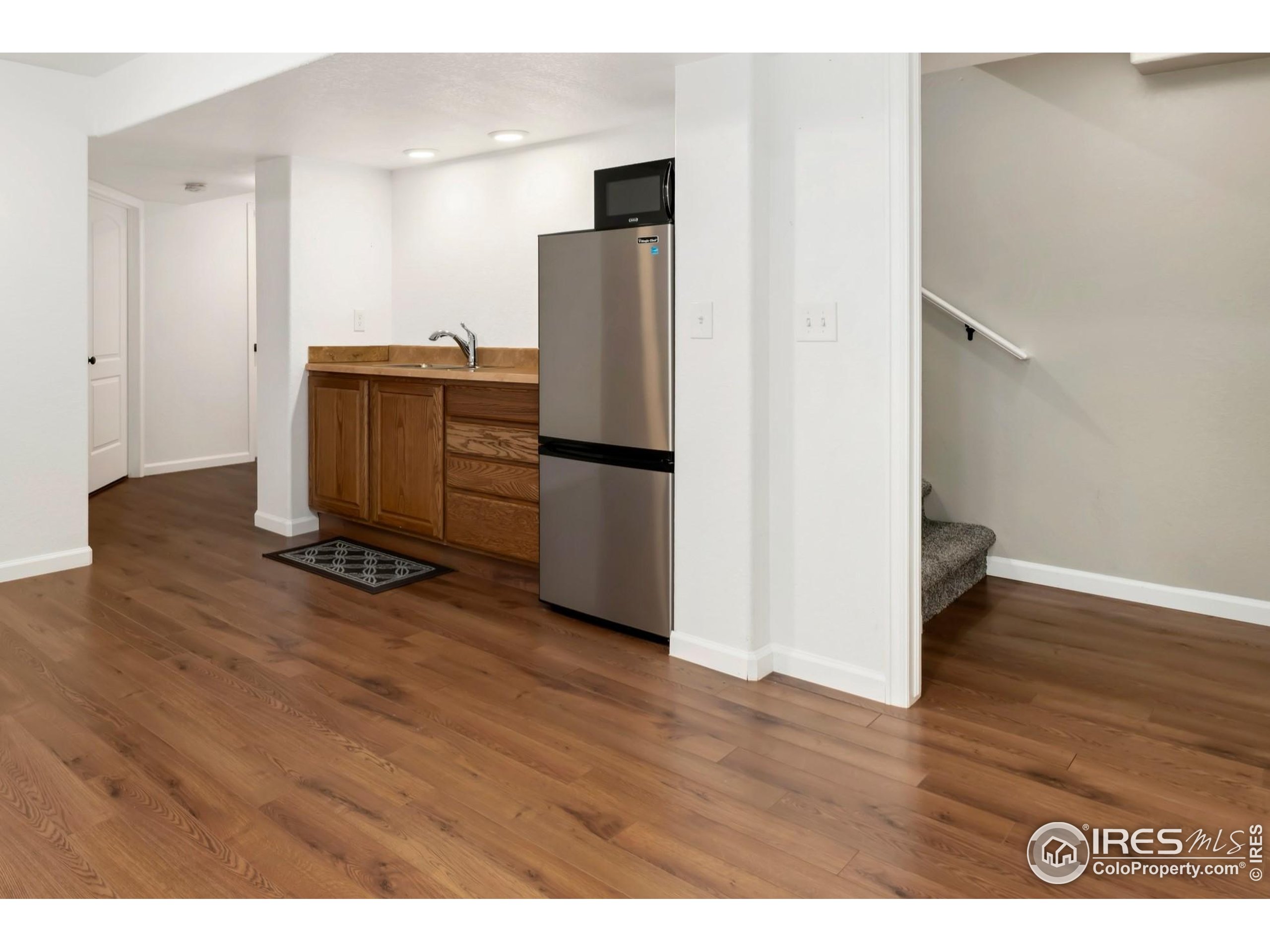 11449 Coal Ridge Street Firestone, CO 80504 - Photo 27 of 33 a view of a kitchen with wooden floor and electronic appliances