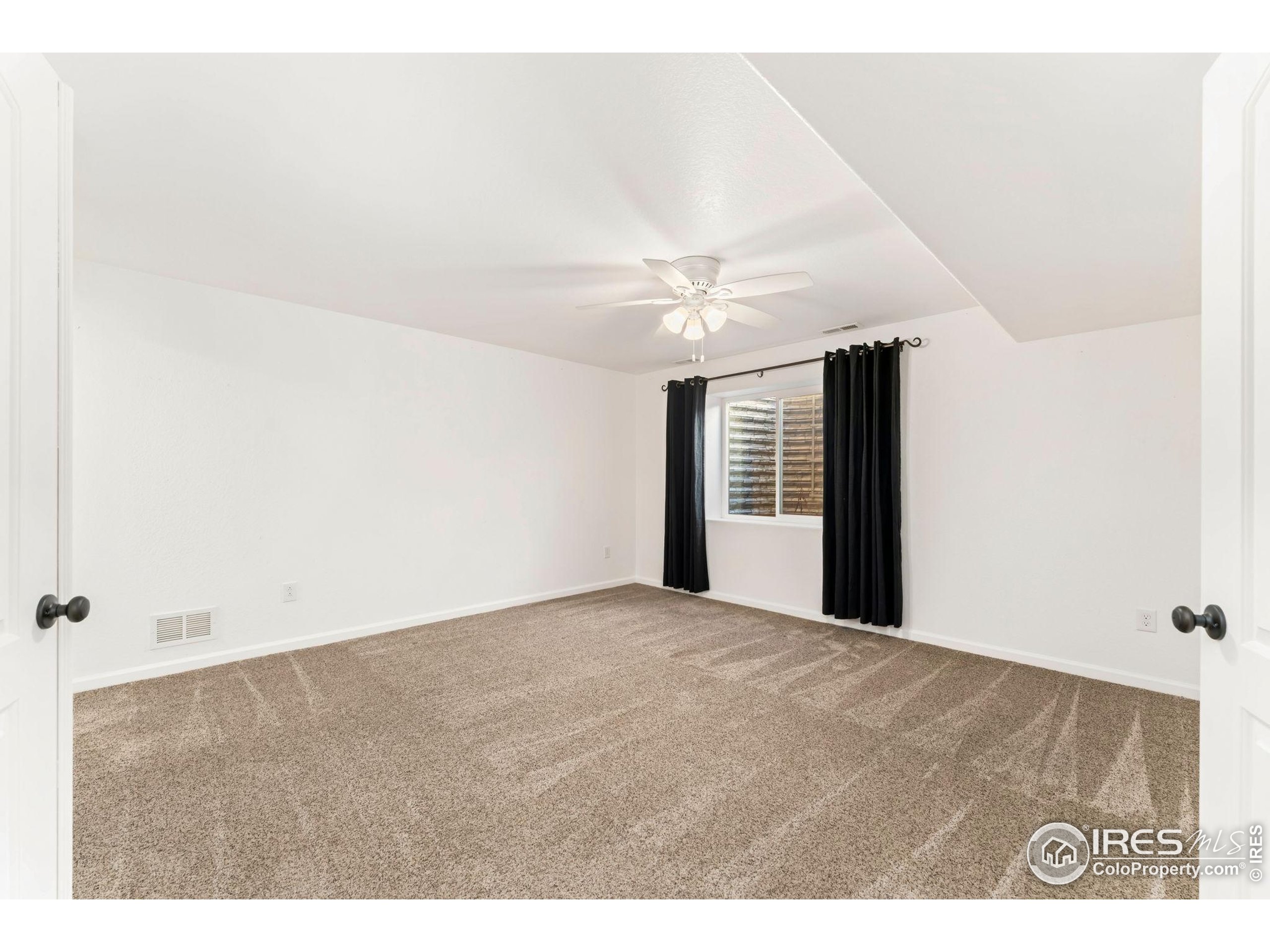 11449 Coal Ridge Street Firestone, CO 80504 - Photo 31 of 33 a view of an empty room with a window
