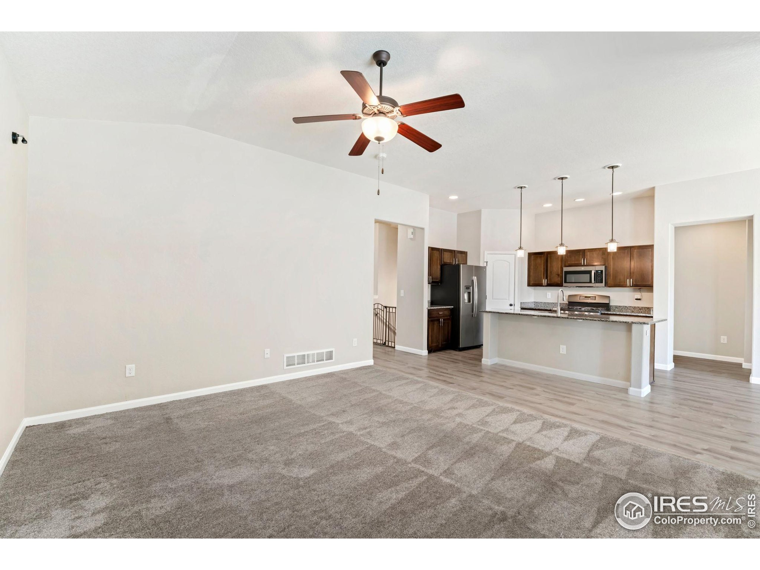 11449 Coal Ridge Street Firestone, CO 80504 - Photo 8 of 33 a view of a kitchen with a sink and a refrigerator