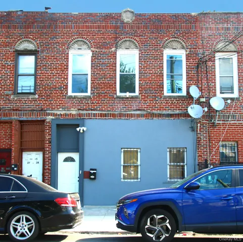 a front view of a house with parking space