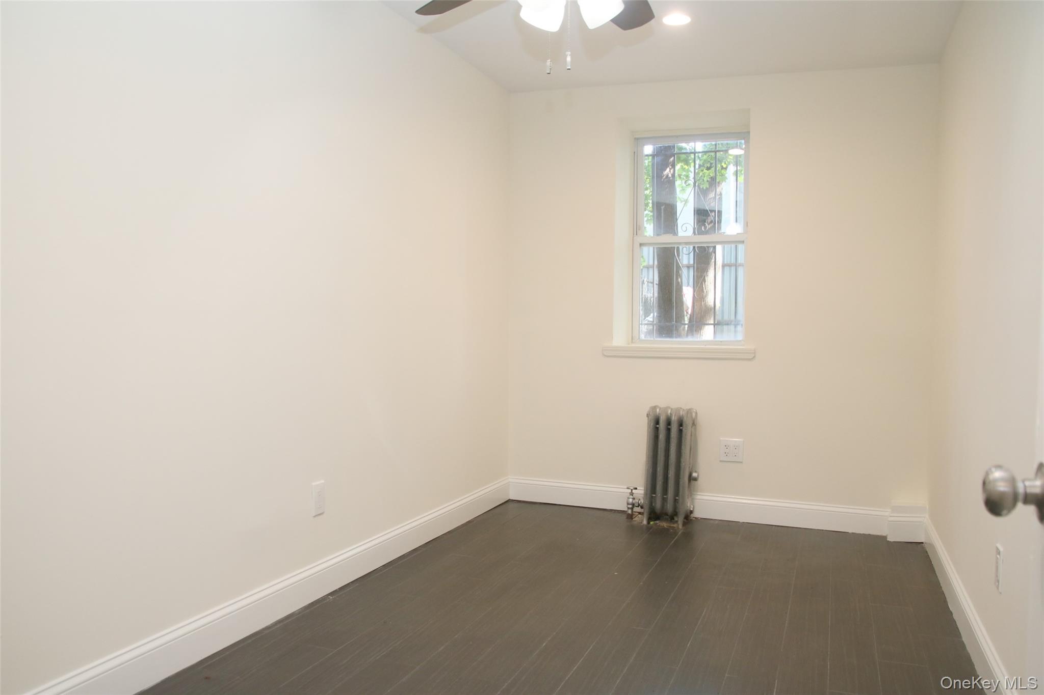 104-07 177th Street Queens, NY 11433 - Photo 8 of 19 an empty room with a window