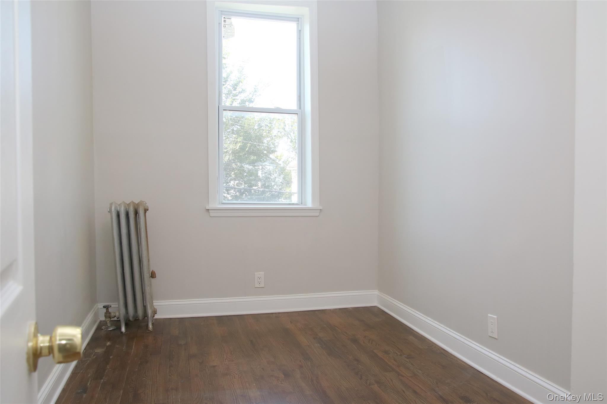 104-07 177th Street Queens, NY 11433 - Photo 10 of 19 an empty room with a window