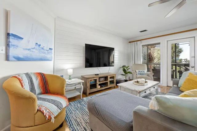 a view of a hallway with wooden floor and entryway