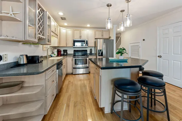 a bathroom with a shower sink vanity mirror and toilet
