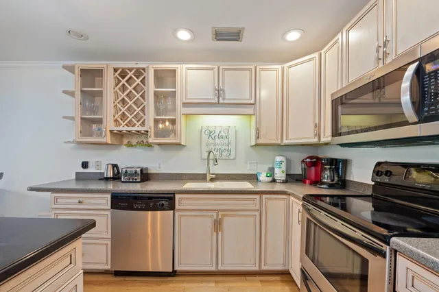 a living room with furniture and kitchen view
