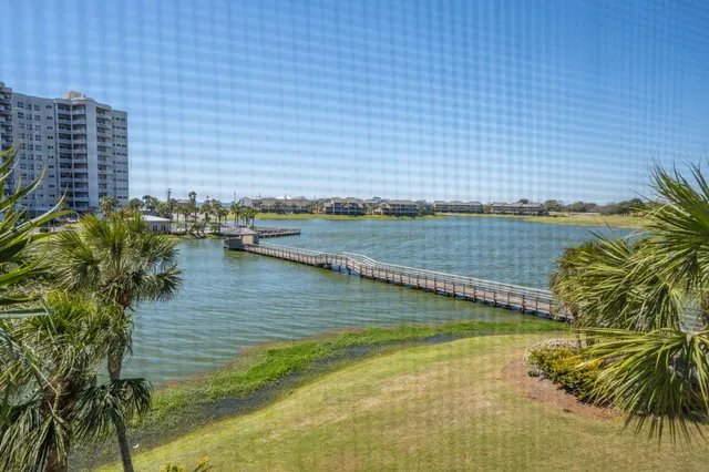 an aerial view of residential houses with outdoor space and swimming pool