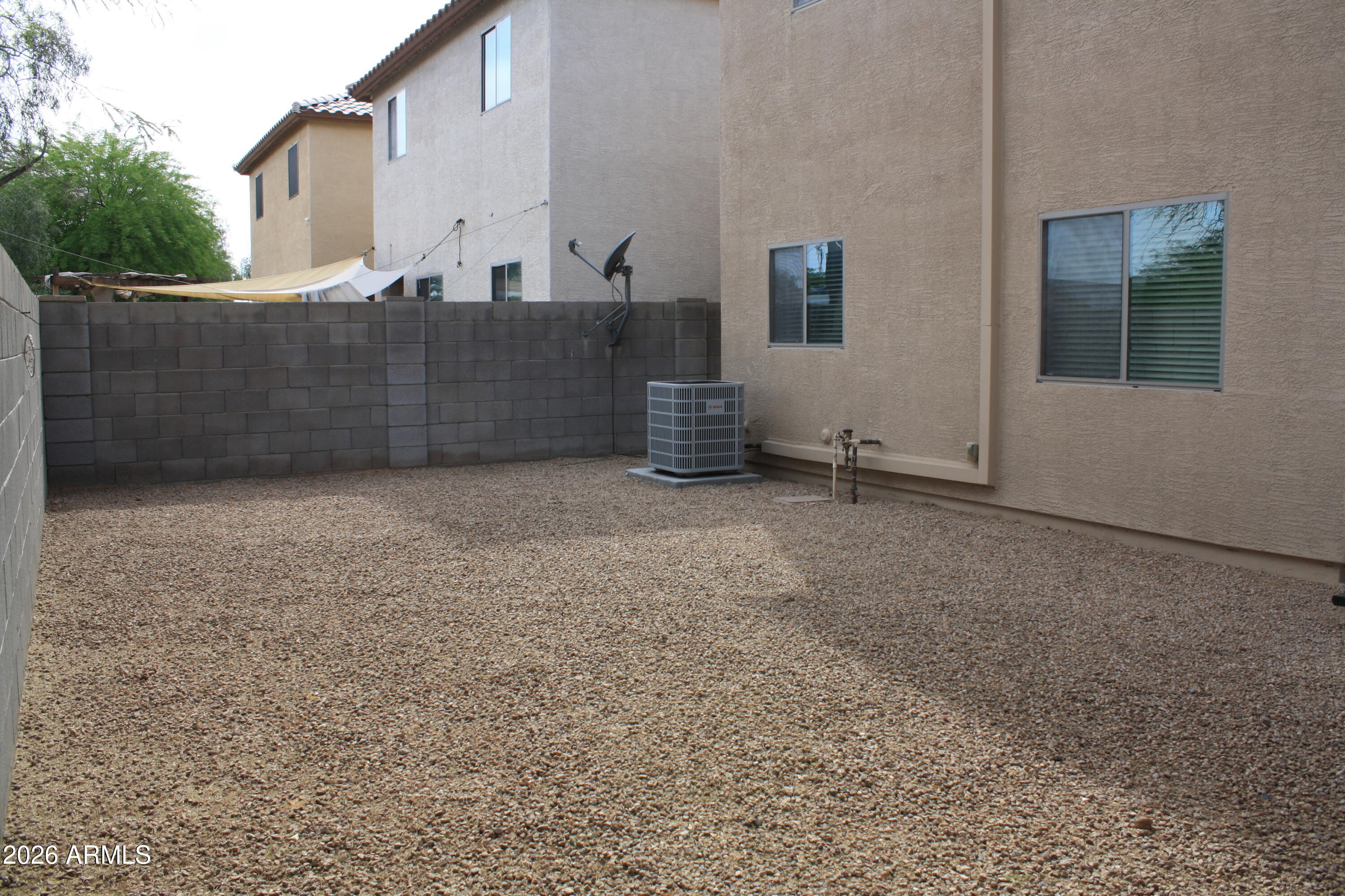 10225 West Camelback Road, Unit 19 Phoenix, AZ 85037 - Photo 42 of 51 a view of an house with backyard