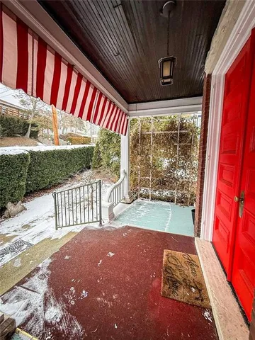 a view of porch with a floor to ceiling window and wooden floor