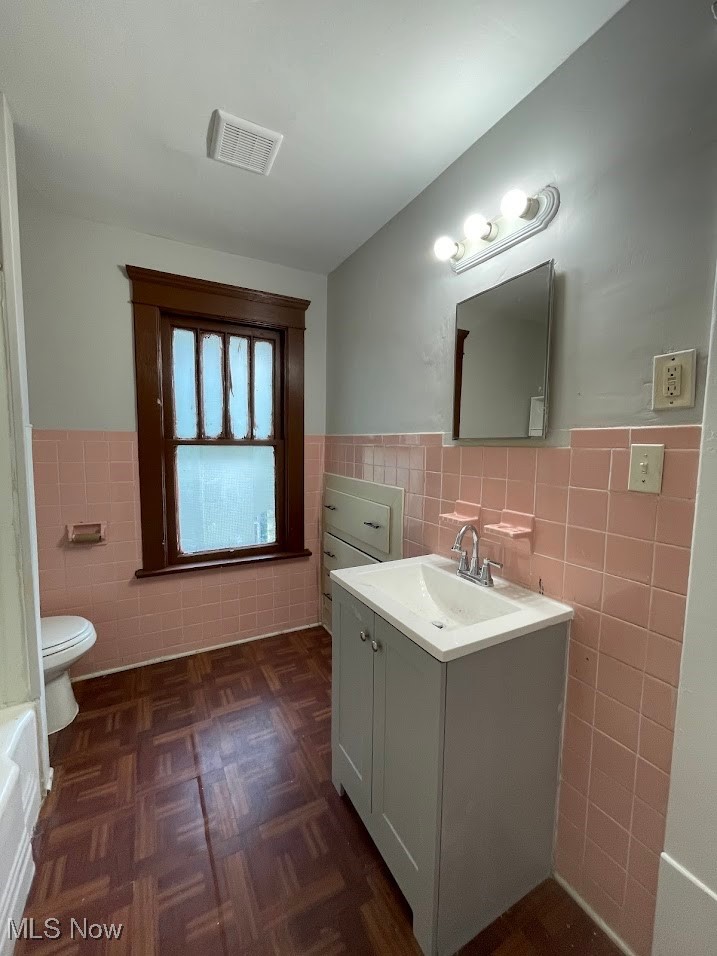 950 Avon Street Akron, OH 44310 - Photo 13 of 15 Bathroom with a wainscoted wall, visible vents, tile walls, and toilet