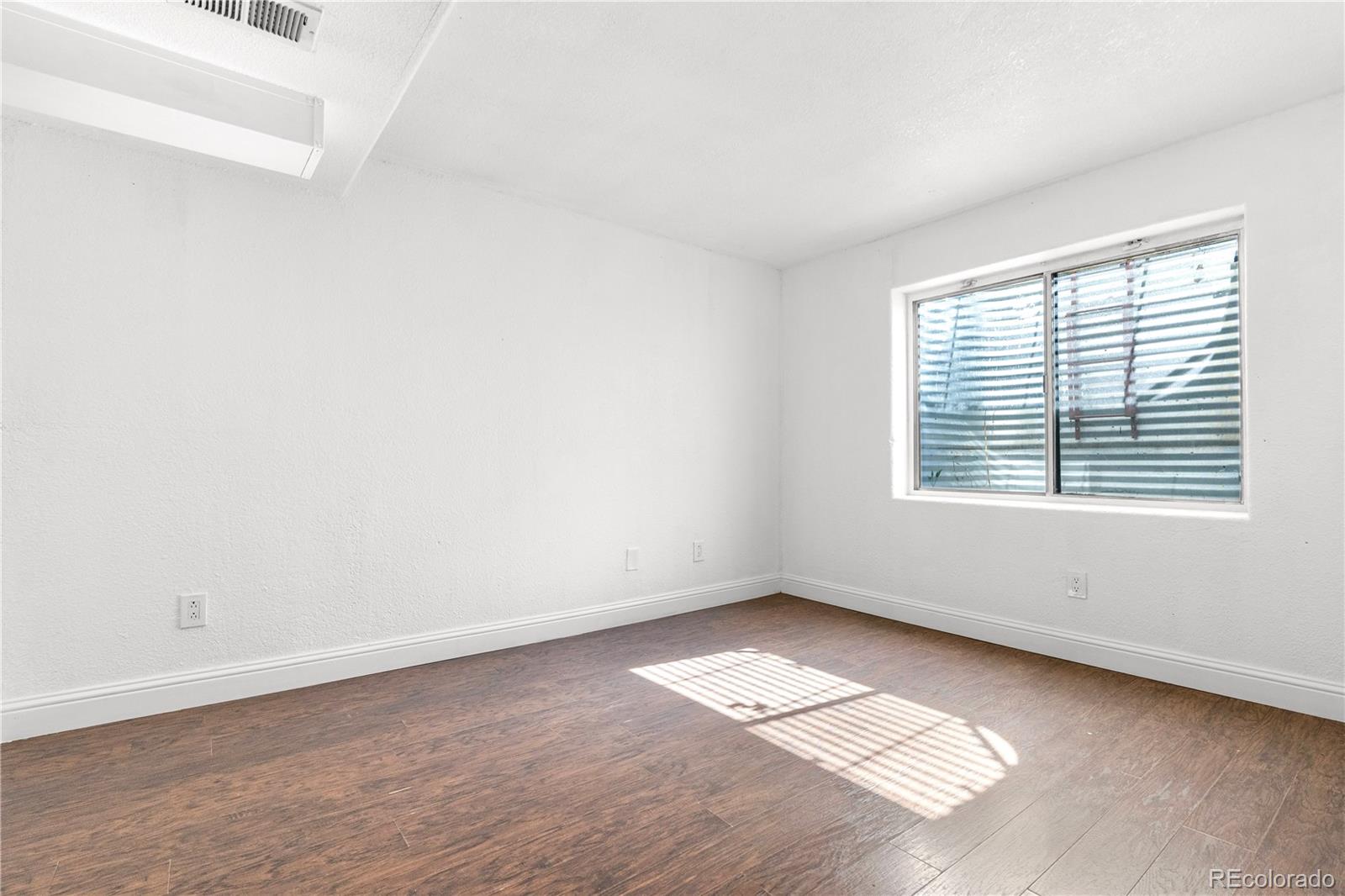 4501 West Alaska Place, Unit B Denver, CO 80219 - Photo 14 of 19 an empty room with a window
