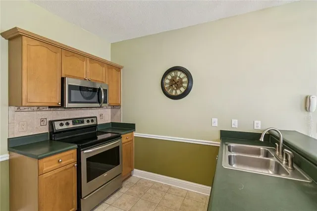 a kitchen with a refrigerator stove and sink
