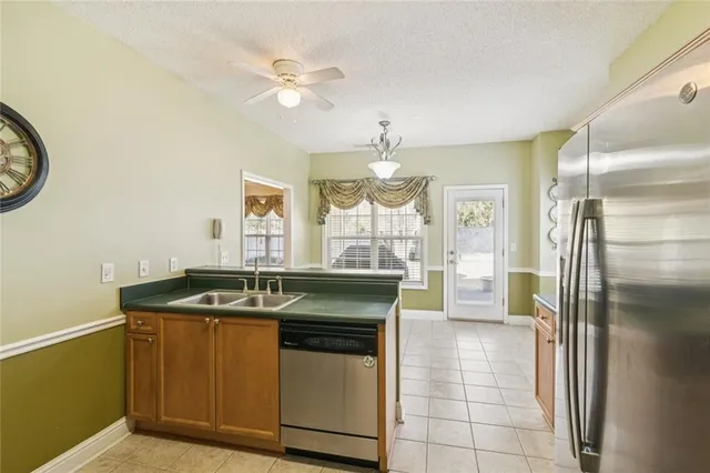 a view of a counter top a sink and chandelier