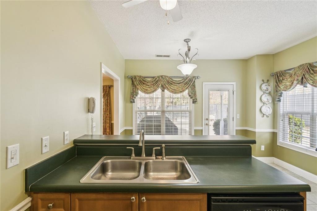 2530 Rosehill Circle Lithia Springs, GA 30122 - Photo 18 of 34 a view of a counter top a sink and chandelier