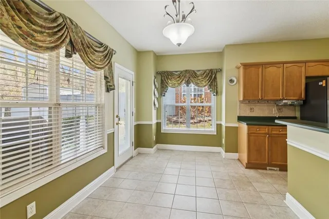 a spacious bedroom with a bed and a chandelier