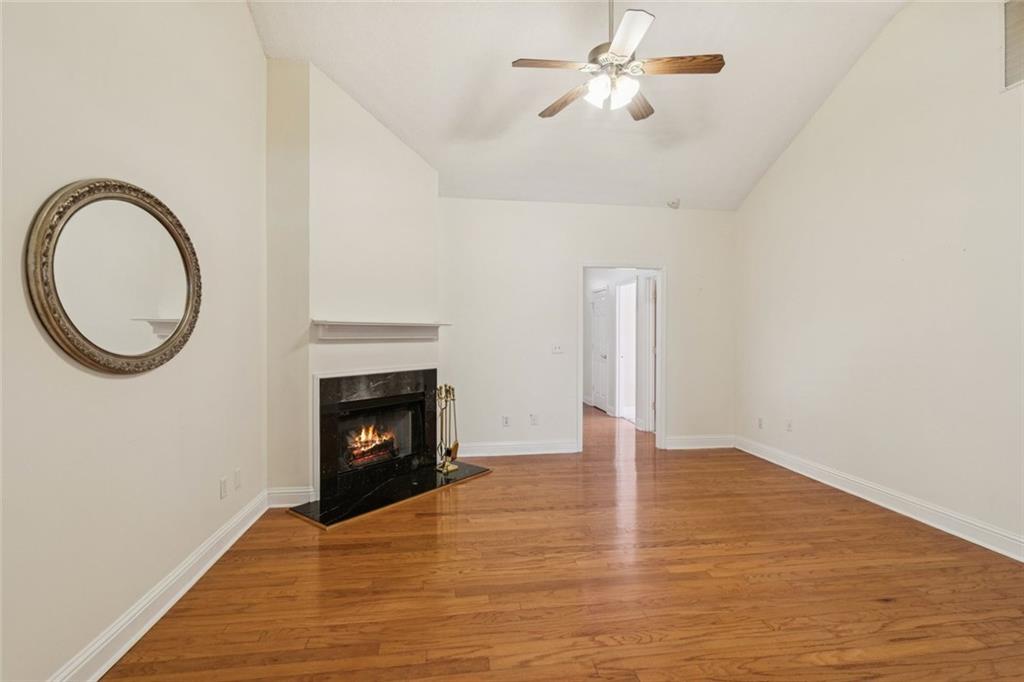 2530 Rosehill Circle Lithia Springs, GA 30122 - Photo 5 of 34 a view of an empty room with wooden floor and a fireplace
