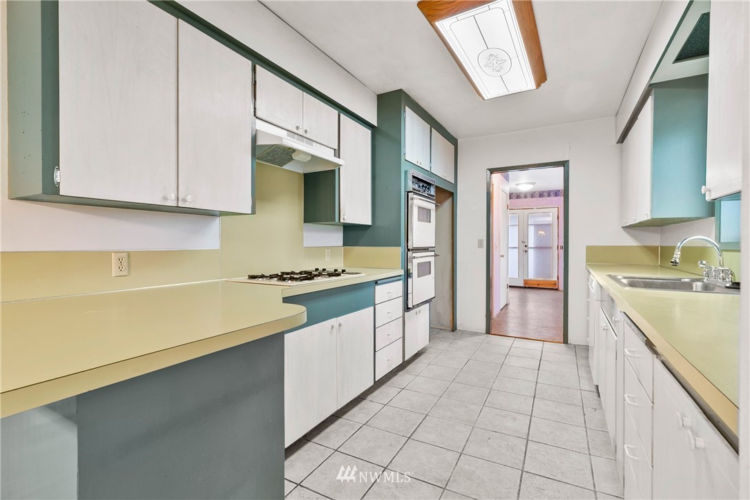 519 Quince Street Northeast Olympia, WA 98506 - Photo 13 of 39 a kitchen with stainless steel appliances a sink stove and cabinets