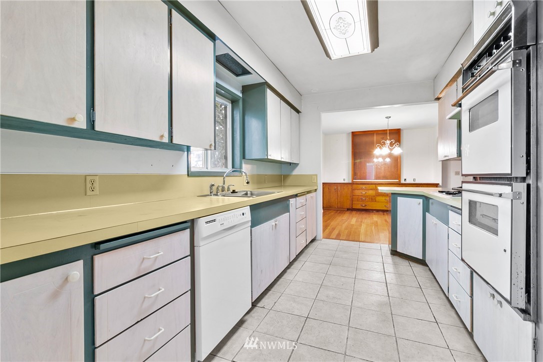 519 Quince Street Northeast Olympia, WA 98506 - Photo 14 of 39 a kitchen with a sink stove and cabinets