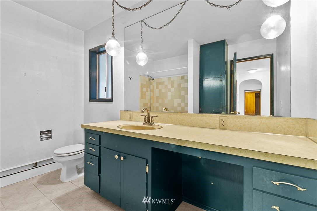 519 Quince Street Northeast Olympia, WA 98506 - Photo 20 of 39 a bathroom with a granite countertop sink a toilet and mirror