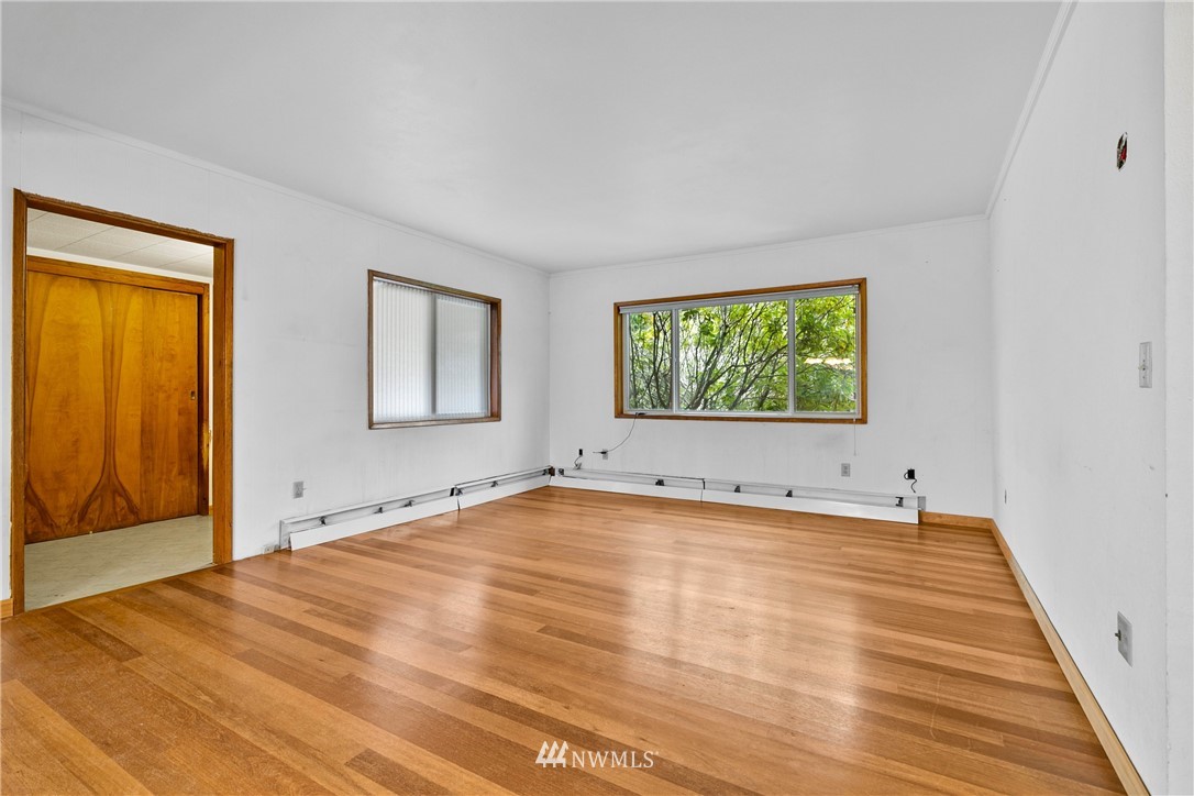 519 Quince Street Northeast Olympia, WA 98506 - Photo 8 of 39 a view of an empty room with a window and wooden floor