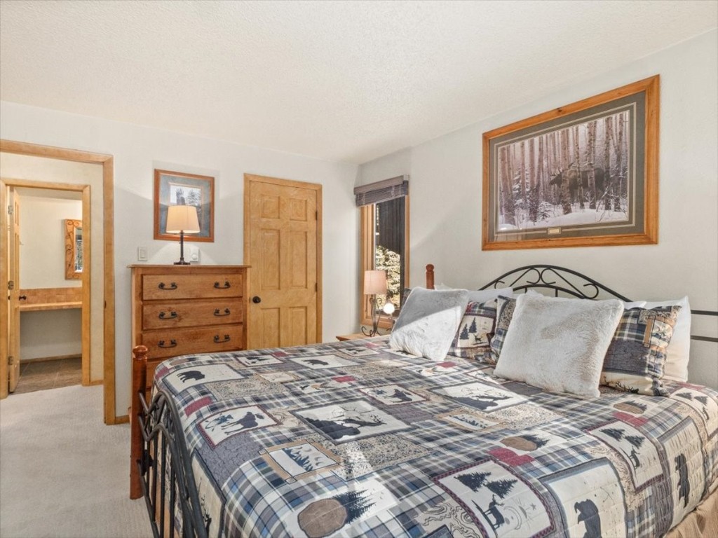 108 Guller Road, Unit B4 Copper Mountain, CO 80443 - Photo 14 of 21 a bedroom with a bed and a painting on the wall