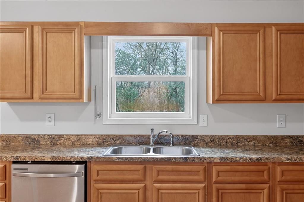 256 Astin Creek Road Villa Rica, GA 30180 - Photo 12 of 38 a kitchen with granite countertop cabinets sink and window