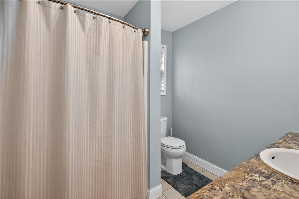 256 Astin Creek Road Villa Rica, GA 30180 - Photo 17 of 38 a bathroom with a toilet and a shower curtain
