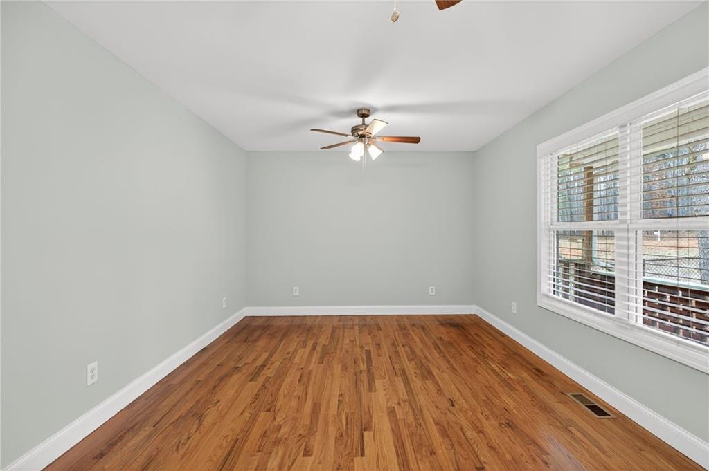 256 Astin Creek Road Villa Rica, GA 30180 - Photo 5 of 38 a view of a room with wooden floor and a ceiling fan