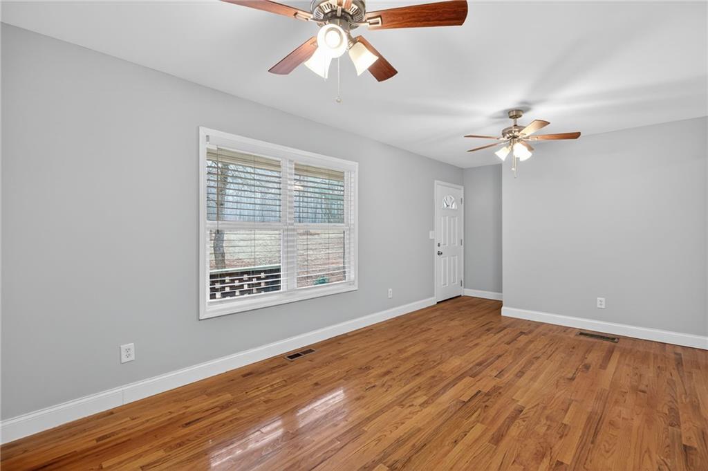 256 Astin Creek Road Villa Rica, GA 30180 - Photo 6 of 38 a view of an empty room with a window and a ceiling fan