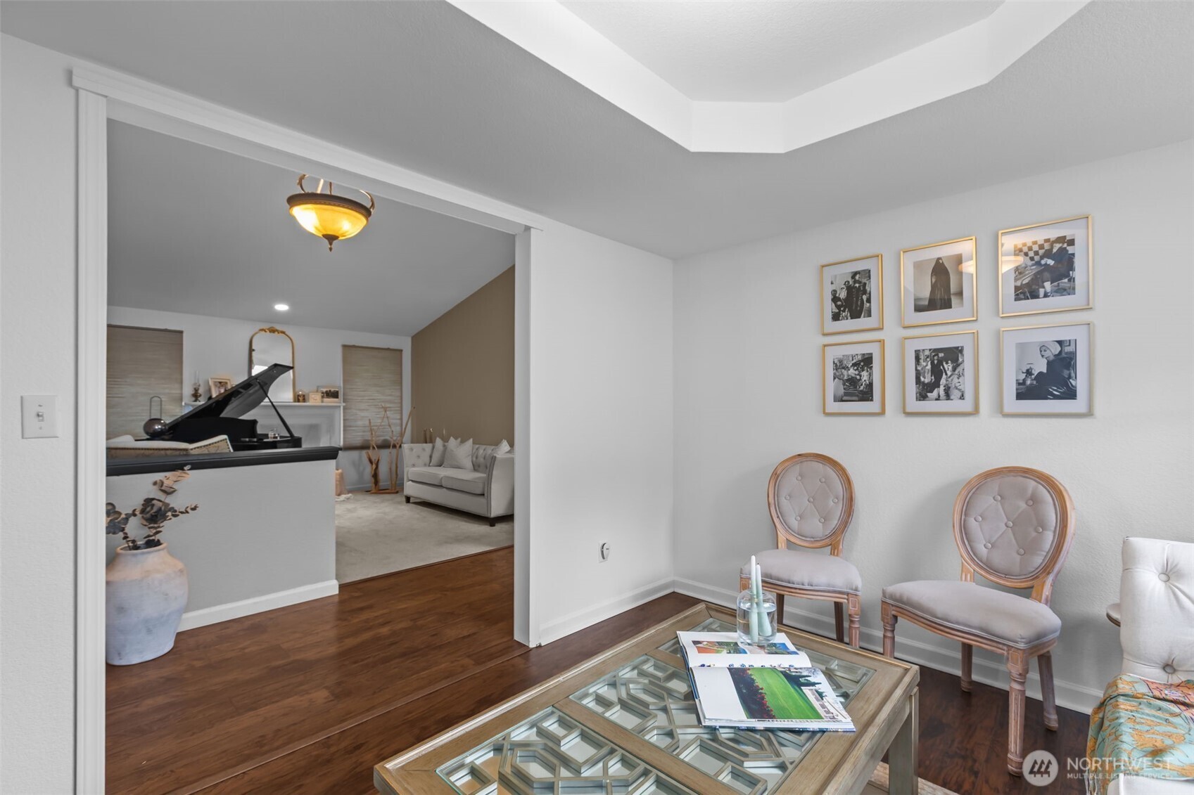1073 Southwest 326th Street Federal Way, WA 98023 - Photo 15 of 31 a view of a dining room and livingroom with furniture wooden floor mirror and a chandelier
