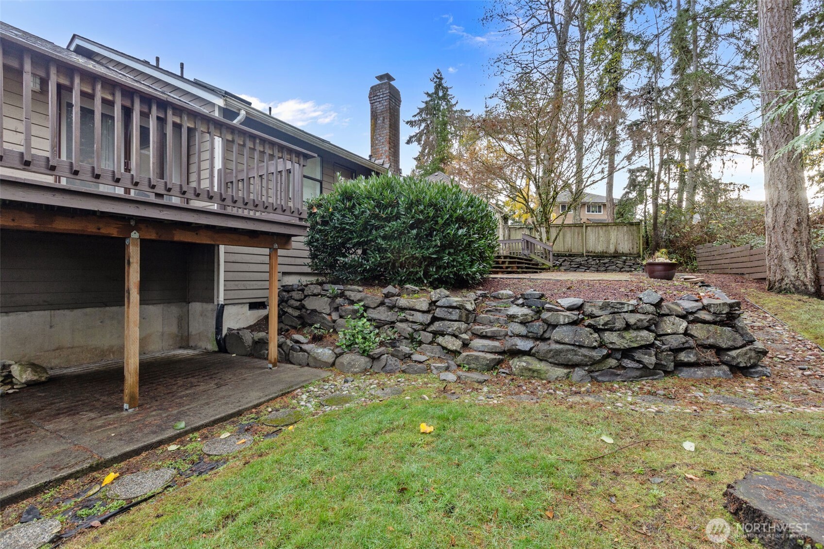 1073 Southwest 326th Street Federal Way, WA 98023 - Photo 24 of 31 a view of a house with a large tree and wooden fence