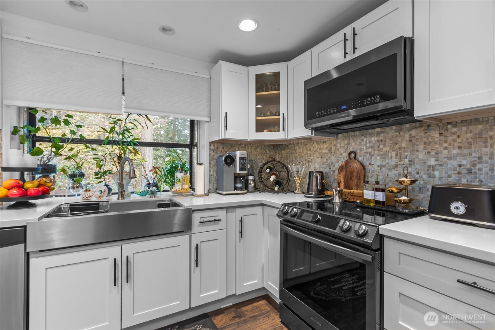 1073 Southwest 326th Street Federal Way, WA 98023 - Photo 7 of 31 a kitchen with stainless steel appliances a sink a stove a microwave and cabinets