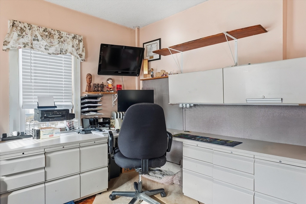30-32 Walnut Street Maynard, MA 01754 - Photo 11 of 38 a room with cabinets and flat screen tv