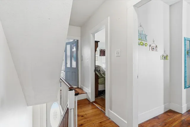 a view of an entryway with wooden floor