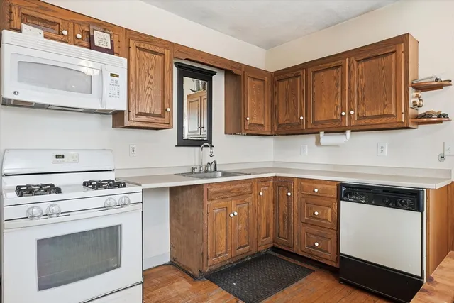 a kitchen with stainless steel appliances granite countertop a stove microwave and cabinets