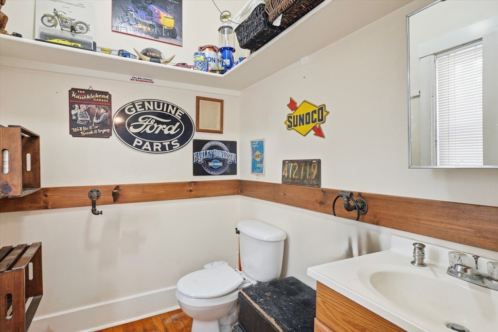 30-32 Walnut Street Maynard, MA 01754 - Photo 21 of 38 a bathroom with a sink a mirror and a toilet