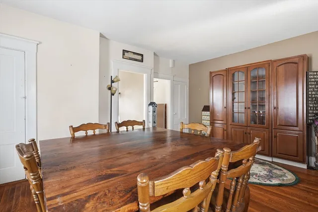 a dining room with furniture and wooden floor